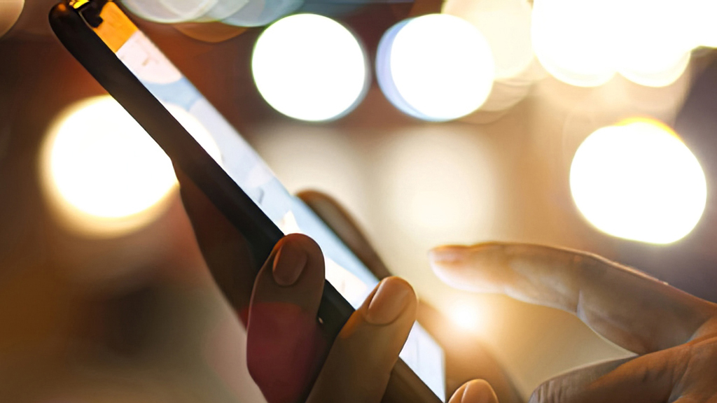 Hands holding a cell phone